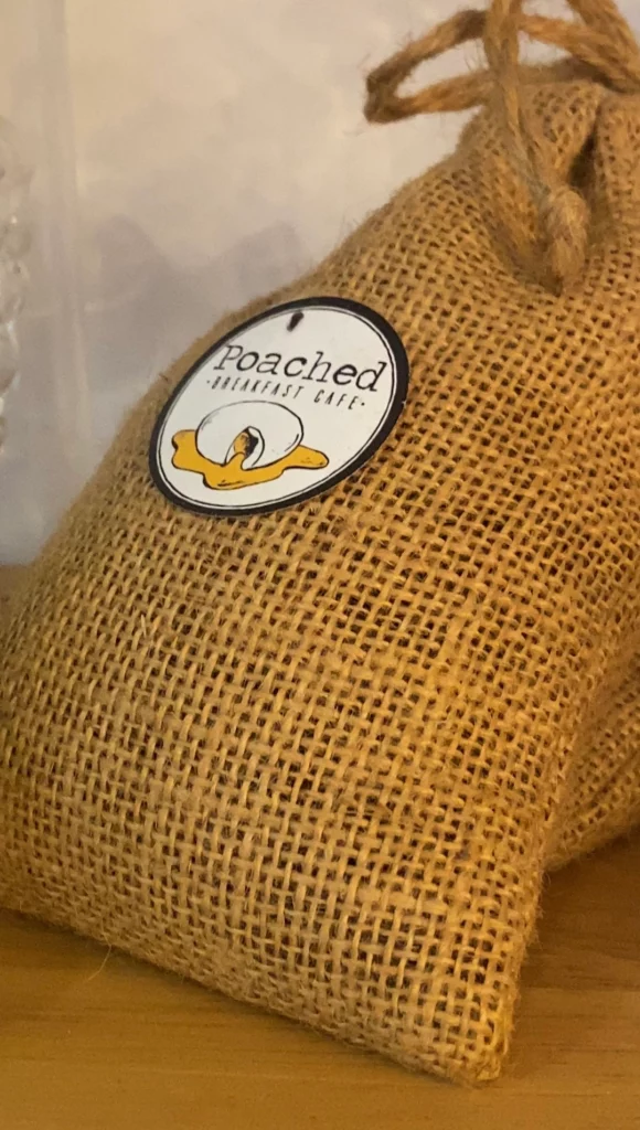 A bag of the best coffee beans in Phuket on the shelf with the Poached logo at Poached Breakfast Cafe, Chalong, Phuket, Thailand
