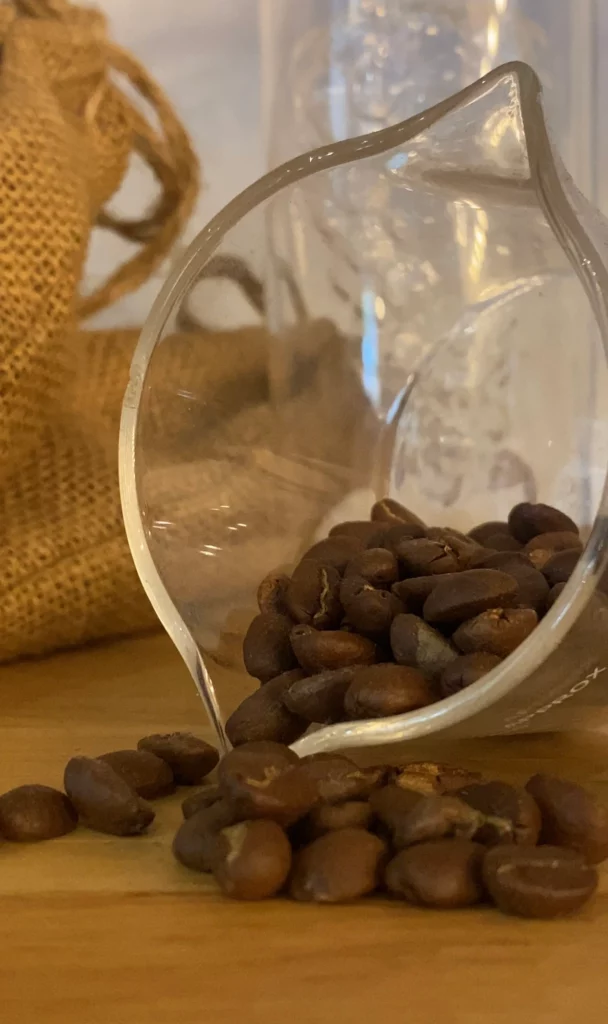 Close up shot of the best coffee beans in Phuket in a glass container all spilling out at Poached Breakfast Cafe, Chalong, Phuket, Thailand