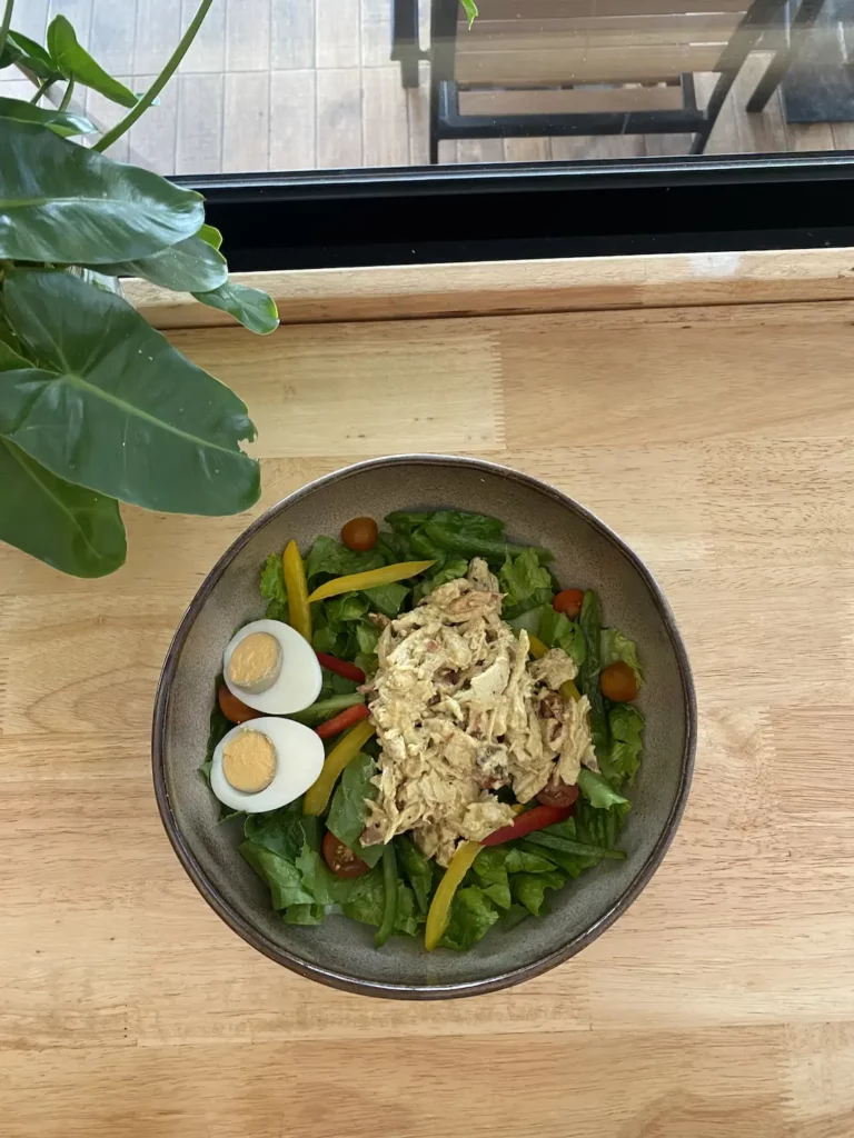 Chicken curry salad with eggs on the table at at the best place for lunch in Chalong - Poached Breakfast Cafe, Chalong, Phuket, Thailand