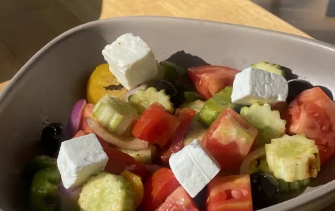 Greek salad with feta, tomatoes, cucumber, onion and olives in the sunshine at Poached Breakfast Cafe: one of the best holiday experiences in Chalong, Phuket, Thailand
