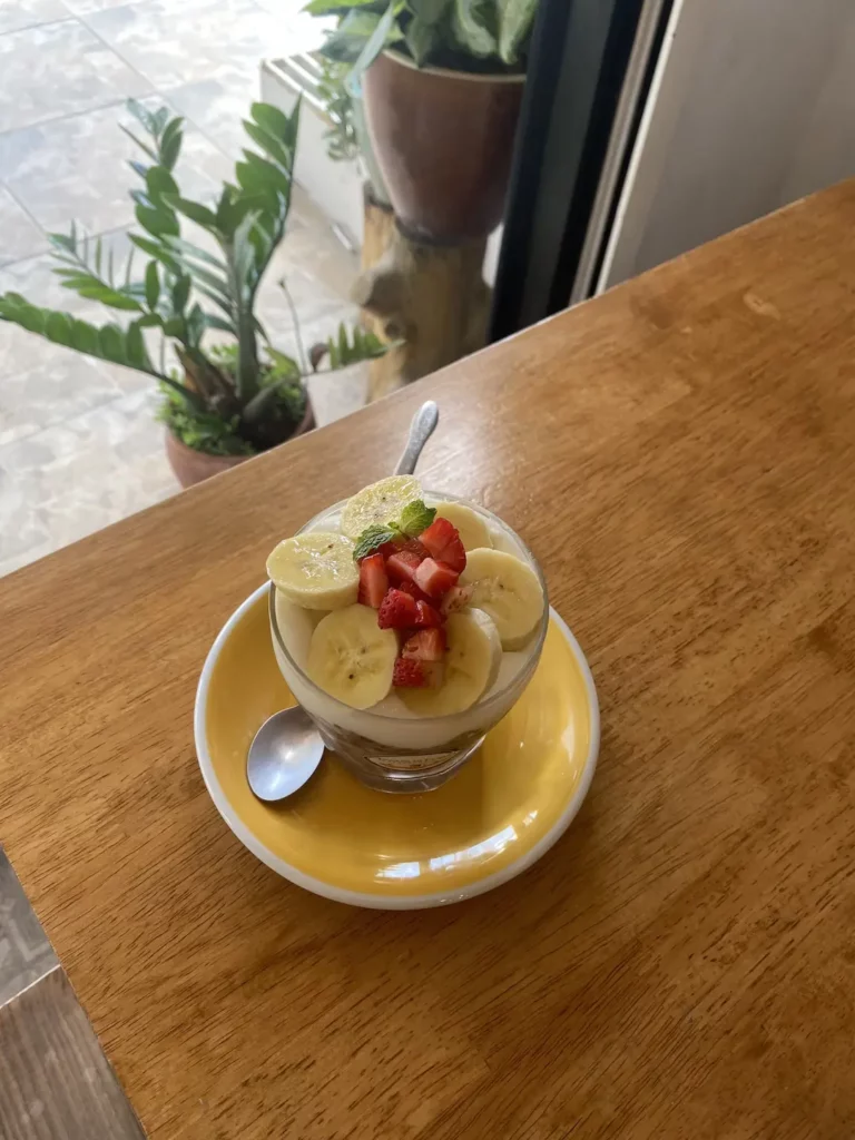 Delicious prana chai granola parfait in a glass, topped with fresh banana and strawberries at Poached Breakfast Cafe: one of the best holiday experiences in Chalong, Phuket, Thailand