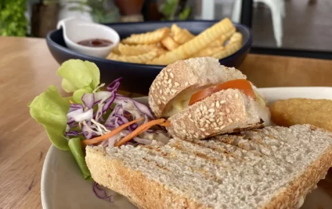 Toasted sandwich on a plate with a side salad and a plate of french fries at the best place for lunch in Chalong - Poached Breakfast Cafe, Chalong, Phuket, Thailand