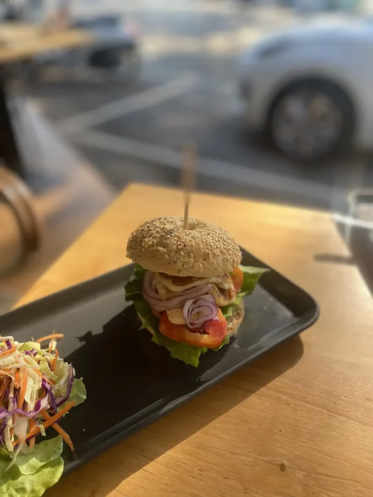 Halloumi Bagel on a table outside at one of the top food spots in Chalong: Poached Breakfast Cafe, Chalong, Phuket, Thailand