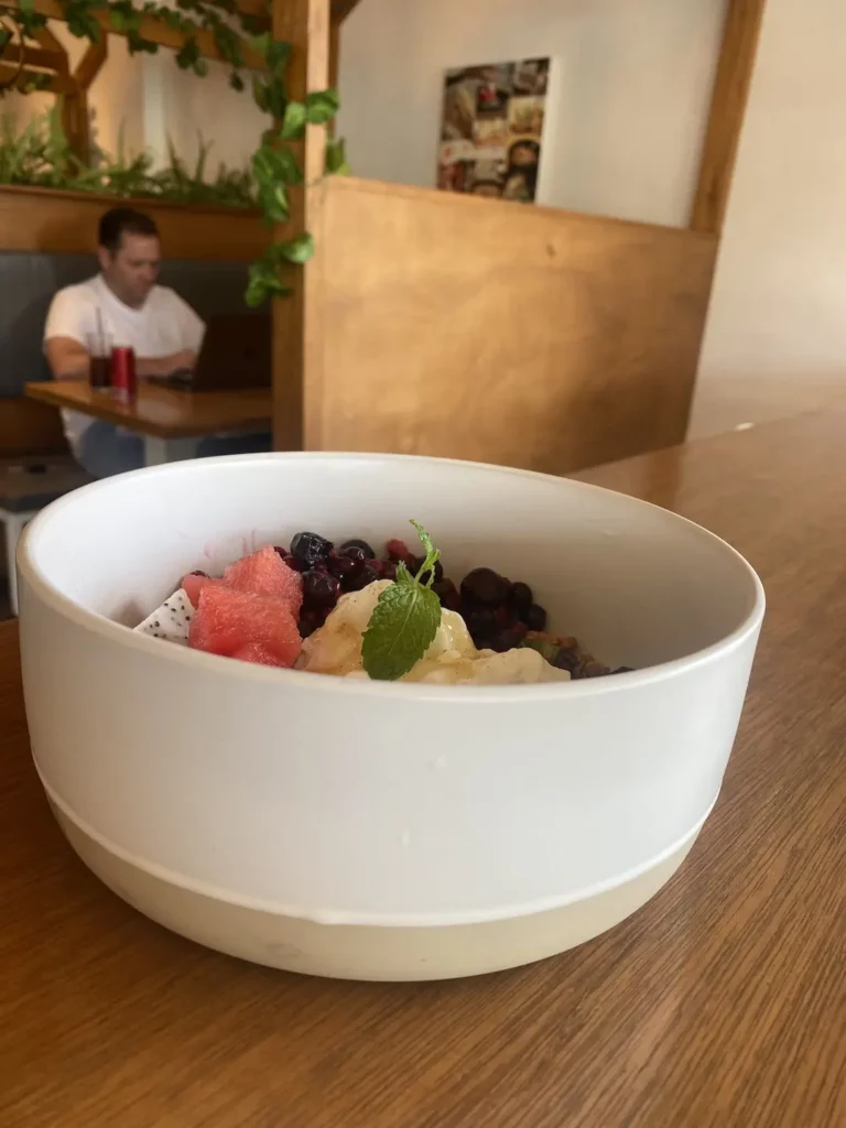 Granola in a large bowl with fresh yoghurt, summer berries, fresh watermelon, dragonfruit and mint at the number one spot in our backpacker food guide in Chalong - Poached Breakfast Cafe, Chalong, Phuket, Thailand