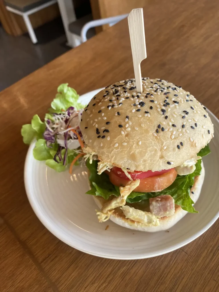 Curried chicken salad sandwich with a skewer in it at the spot with the best coffee nearby Chalong: Poached Breakfast Cafe, Chalong, Phuket, Thailand