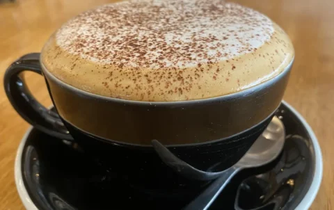 Frothy cappuccino with blurred background at the spot with the best coffee nearby Chalong: Poached Breakfast Cafe, Chalong, Phuket, Thailand