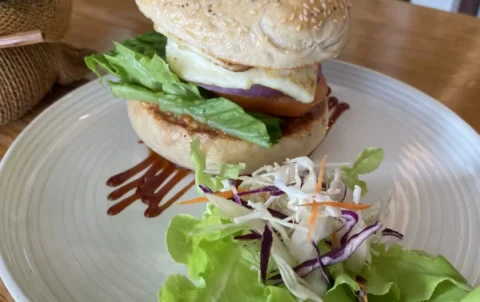 Halloumi bun with smoked bbq cream cheese and salad on a table at the best of the famous cafes in Phuket: Poached Breakfast Cafe, Chalong, Phuket, Thailand