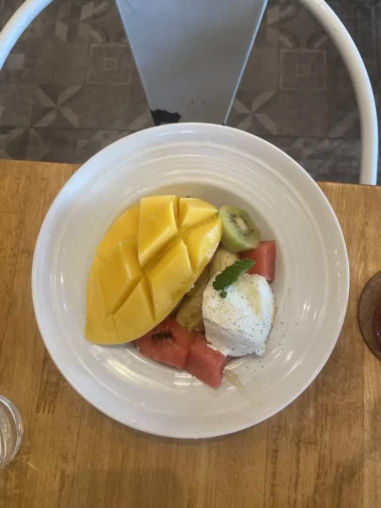 Fruit salad in a bowl on a table. A good alternative to avocado toast in Chalong at Poached Breakfast Cafe, Chalong, Phuket, Thailand