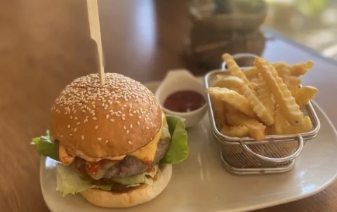 Spicy beef patty in a burger with fries and ketchup and an egg. The best Chalong sandwich which can only be found at Poached Breakfast Cafe, Chalong, Phuket, Thailand