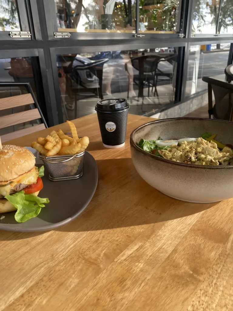 Curried chicken salad on the table with a burger in Chalong at Poached Breakfast Cafe, Chalong, Phuket, Thailand