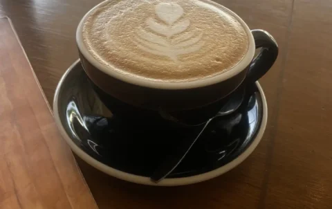 Our smooth, rich latte in a large cup with a leaf design in the foam. Only the best local coffee in Chalong at Poached Breakfast Cafe, Chalong, Phuket, Thailand