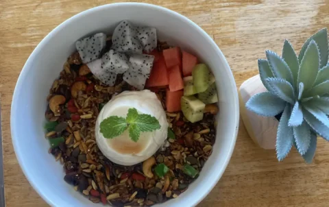 A round bowl filled with dragon fruit, watermelon, granola, nuts and a vanilla panna cotta in the centre, topped with a sprig of mint. This is the perfect meal to refuel before or after a fitness class in Chalong. Only at Poached Breakfast Cafe, Chalong, Phuket, Thailand
