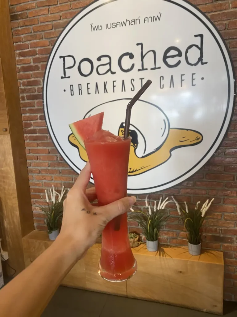 Fresh watermelon juice in a tall glass with a straw and a slice of watermelon on the rim of the glass. This is the perfect meal to refuel before or after a fitness class in Chalong. Only at Poached Breakfast Cafe, Chalong, Phuket, Thailand
