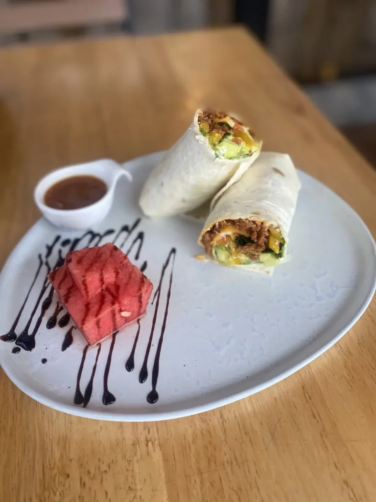 Spicy sausage wrap with a tomato relish and some watermelon drizzled with balsamic reduction. The best meal to eat before a day of island hopping in Phuket.